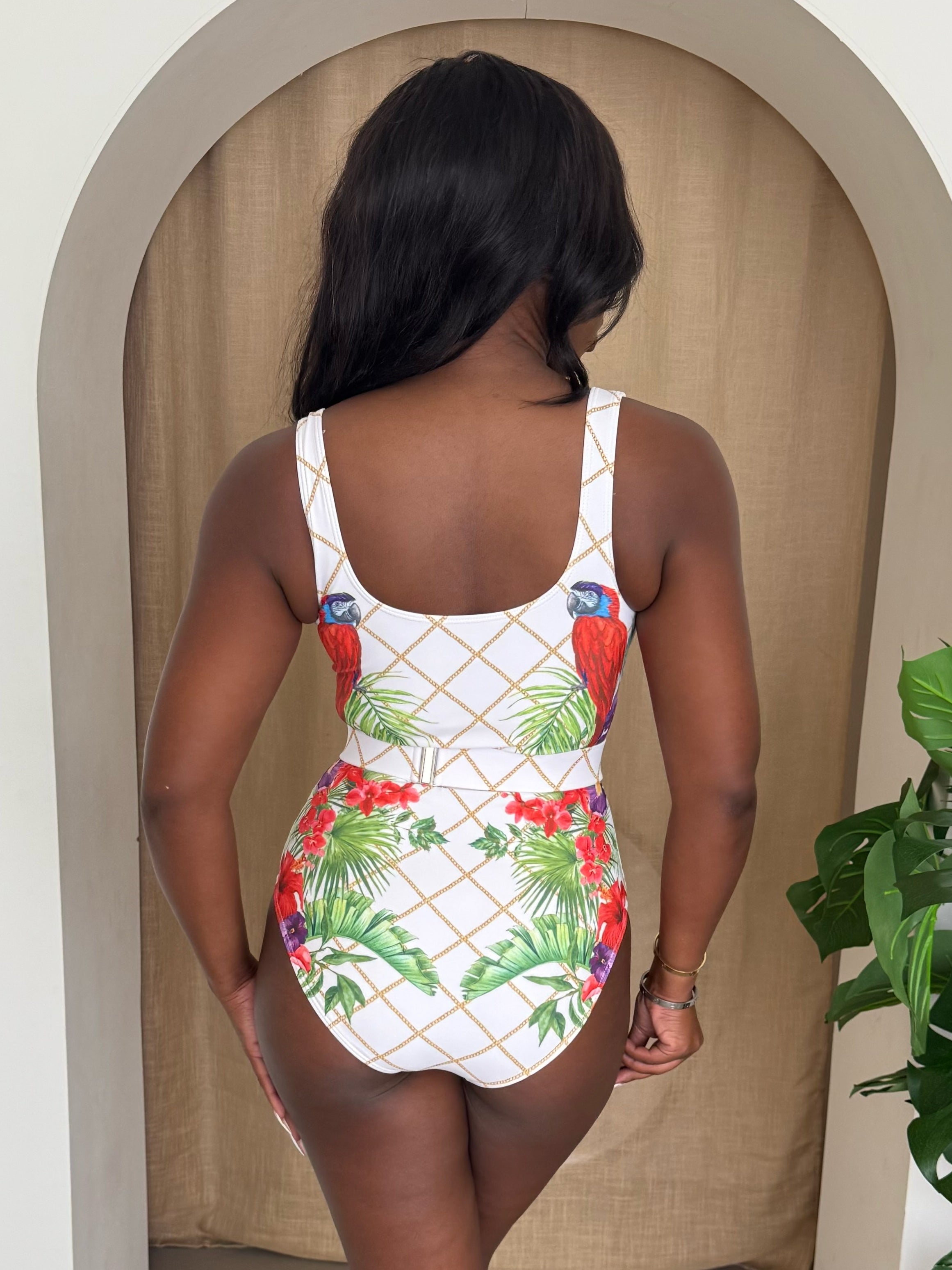 Tropical Elegance – White Swimsuit with Bold Parrot and Red Floral Design